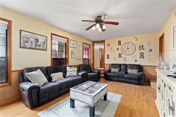 a spacious bedroom with a bed and a flat screen tv