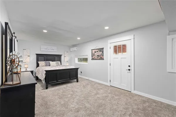 a spacious bedroom with a bed and window
