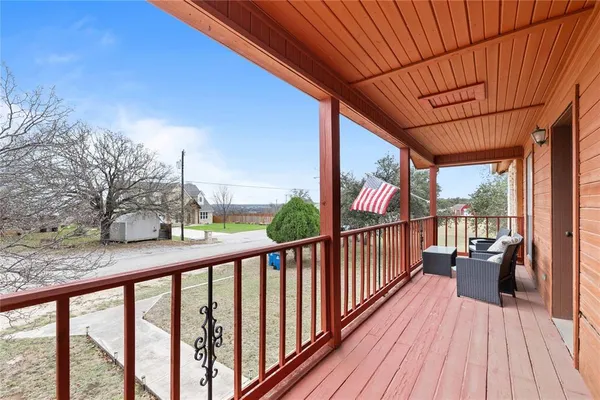 a balcony with furniture and a potted plant