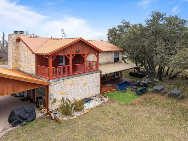 an aerial view of a house with a yard