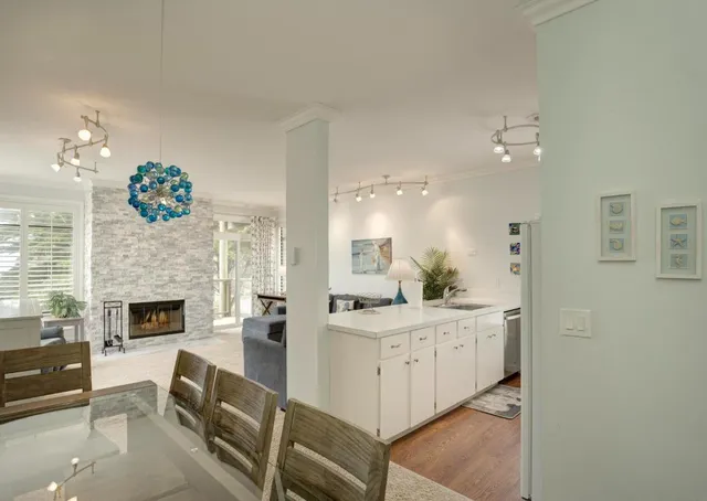 a living room with furniture a fireplace and a chandelier