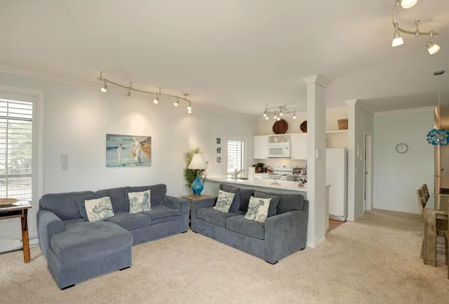 a living room with furniture and a chandelier