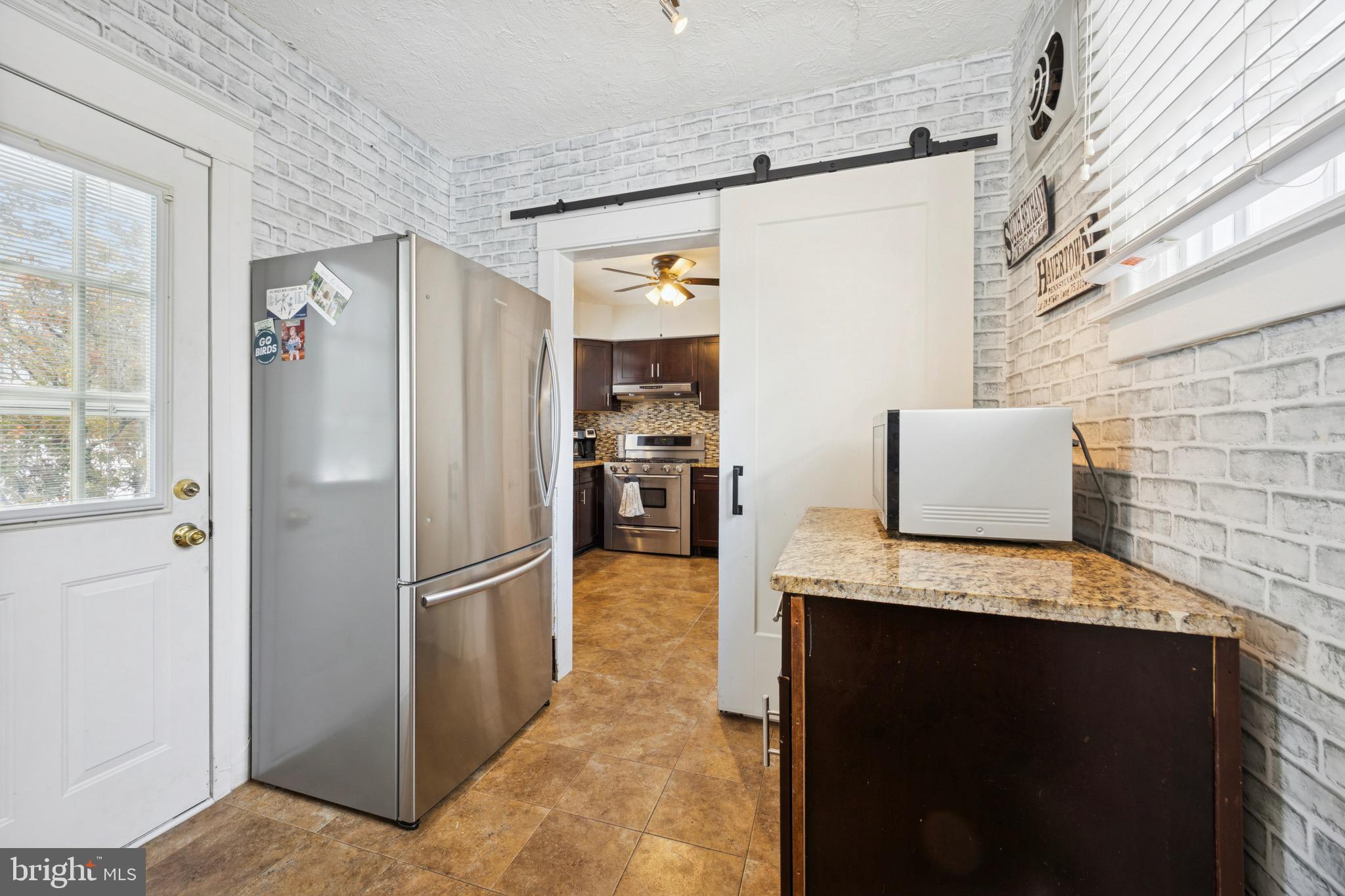 120 West Springfield Road Springfield, PA 19064 - Photo 12 of 35 a kitchen with stainless steel appliances granite countertop a refrigerator and a stove