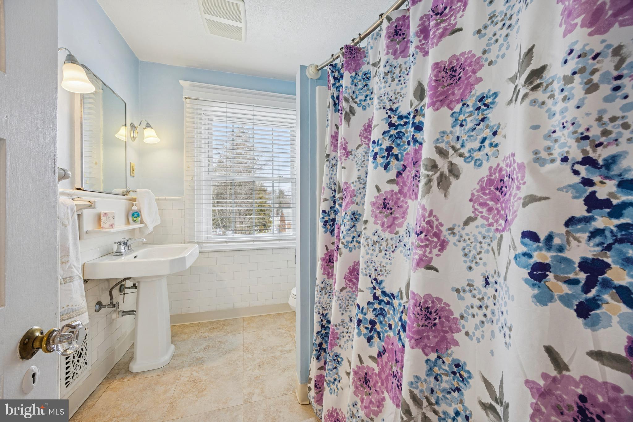120 West Springfield Road Springfield, PA 19064 - Photo 15 of 35 a bathroom with a sink and a mirror