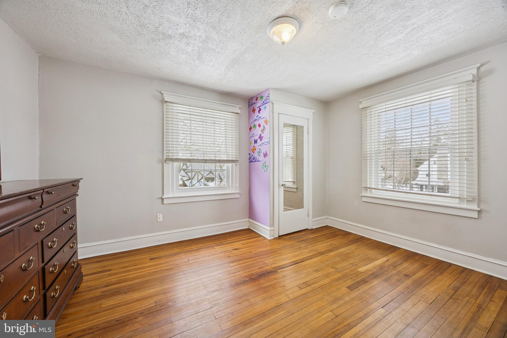 120 West Springfield Road Springfield, PA 19064 - Photo 16 of 35 an empty room with wooden floor and windows