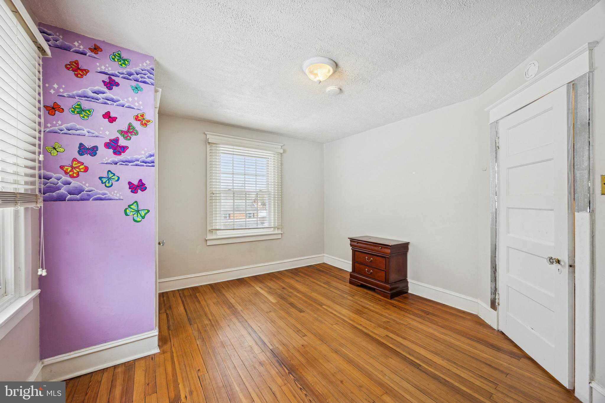 120 West Springfield Road Springfield, PA 19064 - Photo 18 of 35 a view of an empty room with wooden floor and a window