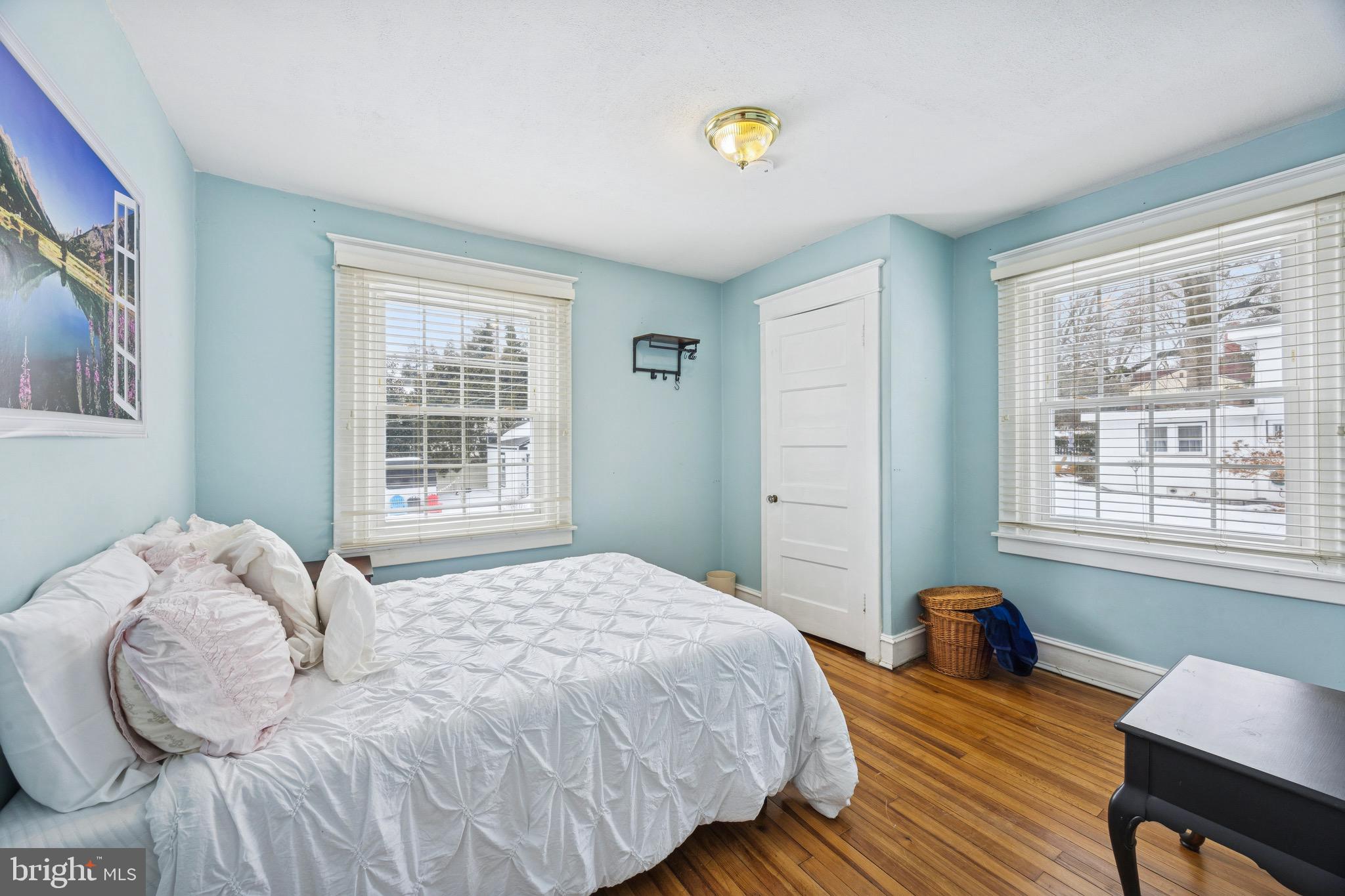 120 West Springfield Road Springfield, PA 19064 - Photo 19 of 35 a bedroom with a bed wooden floor and a window