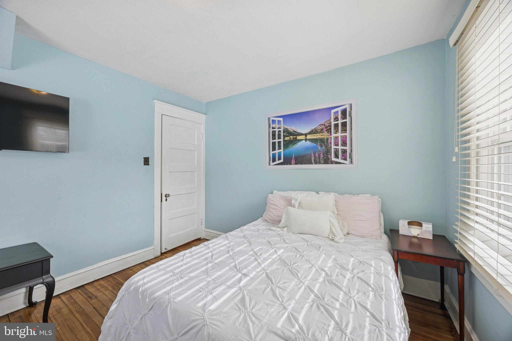 120 West Springfield Road Springfield, PA 19064 - Photo 20 of 35 a bedroom with a bed and a flat screen tv