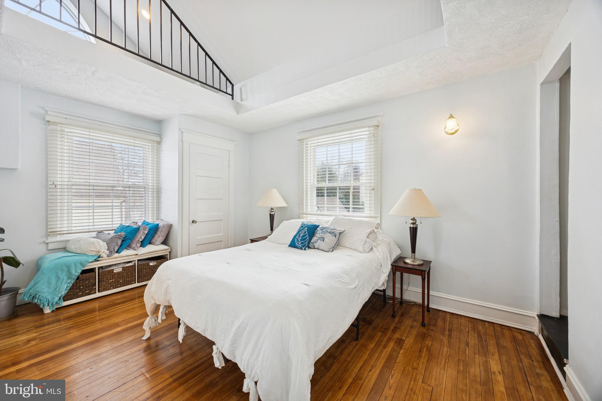 120 West Springfield Road Springfield, PA 19064 - Photo 22 of 35 a bedroom with a bed a table and windows