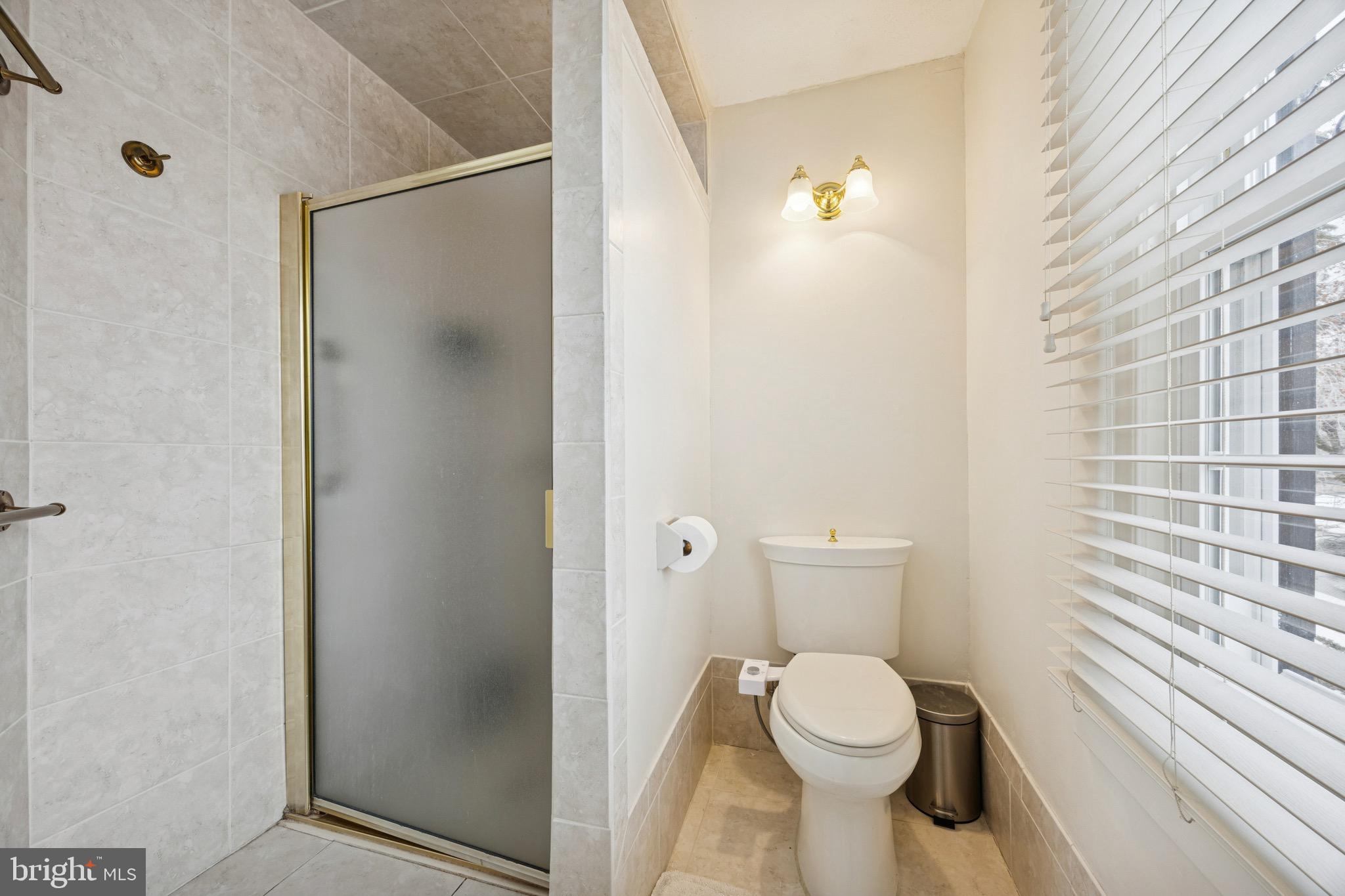 120 West Springfield Road Springfield, PA 19064 - Photo 26 of 35 a white toilet sitting next to a bathroom sink and a shower