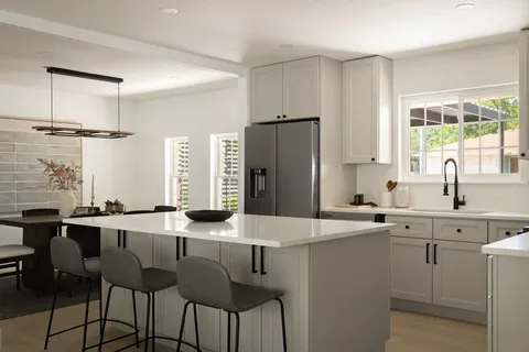 a kitchen with stainless steel appliances a sink and a refrigerator
