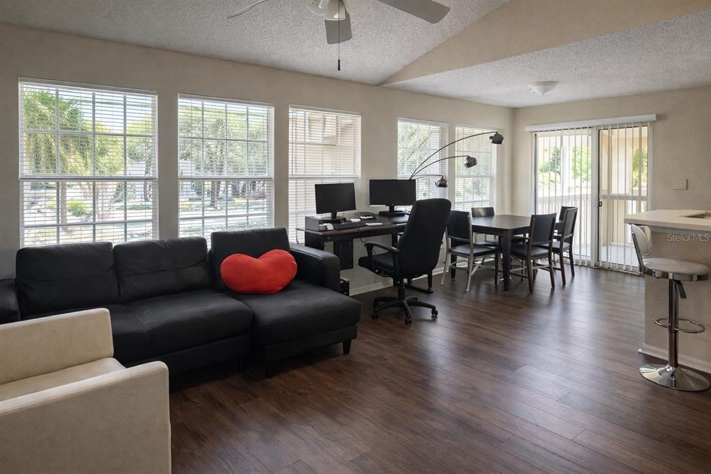 1049 South Hiawassee Road, Unit 3422 Orlando, FL 32835 - Photo 3 of 14 a living room with furniture wooden floor and floor to ceiling windows