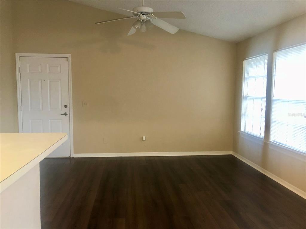 1049 South Hiawassee Road, Unit 3422 Orlando, FL 32835 - Photo 6 of 14 an empty room with wooden floor and windows