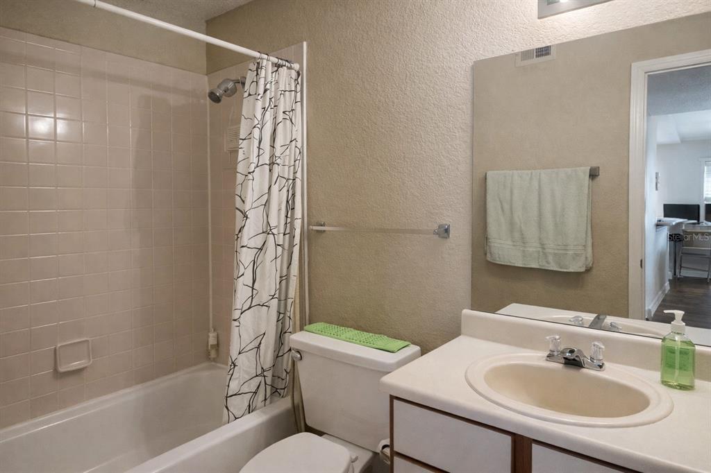 1049 South Hiawassee Road, Unit 3422 Orlando, FL 32835 - Photo 7 of 14 a bathroom with a sink toilet and shower