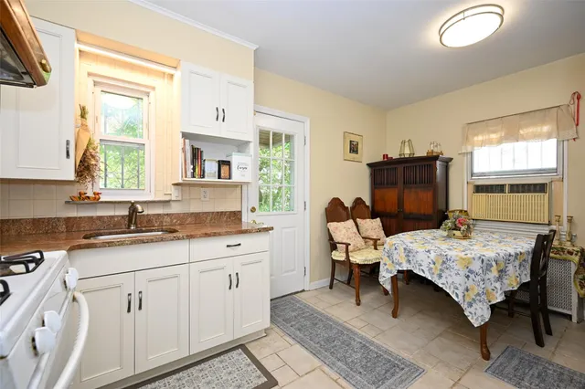a bedroom with a bed and large windows