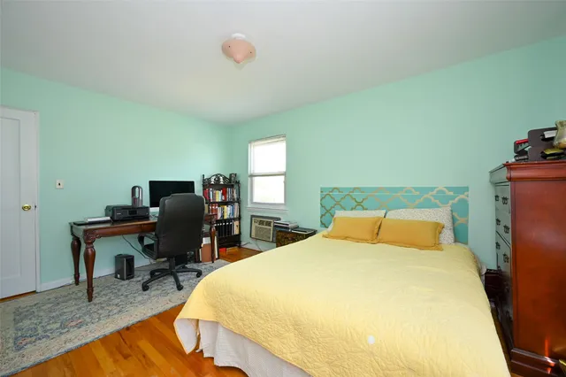 a bedroom with a bed and chair