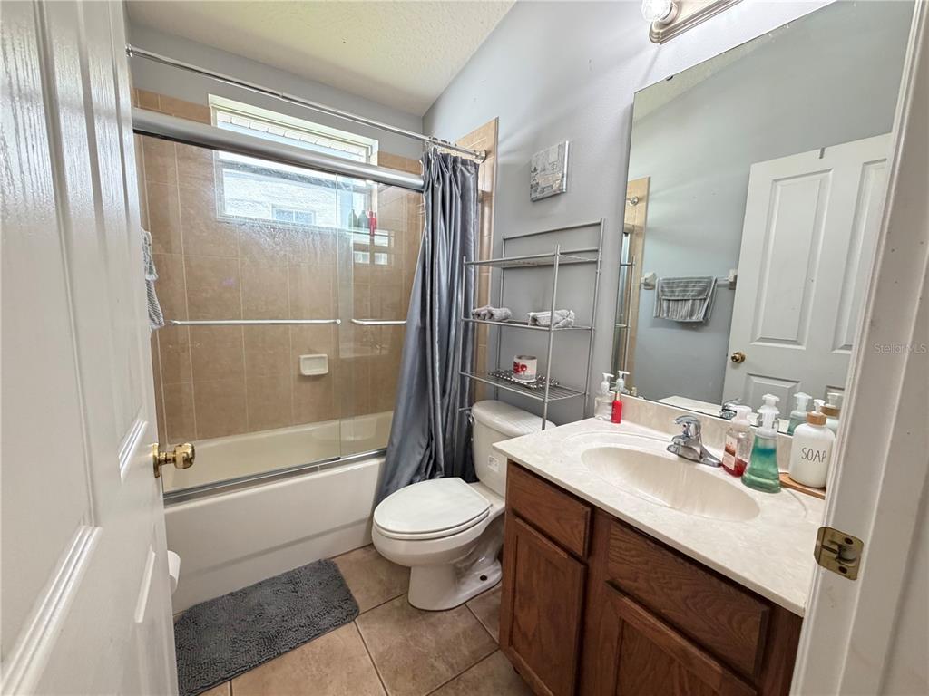 945 Tramells Trail Kissimmee, FL 34744 - Photo 17 of 36 a bathroom with a sink a toilet and shower