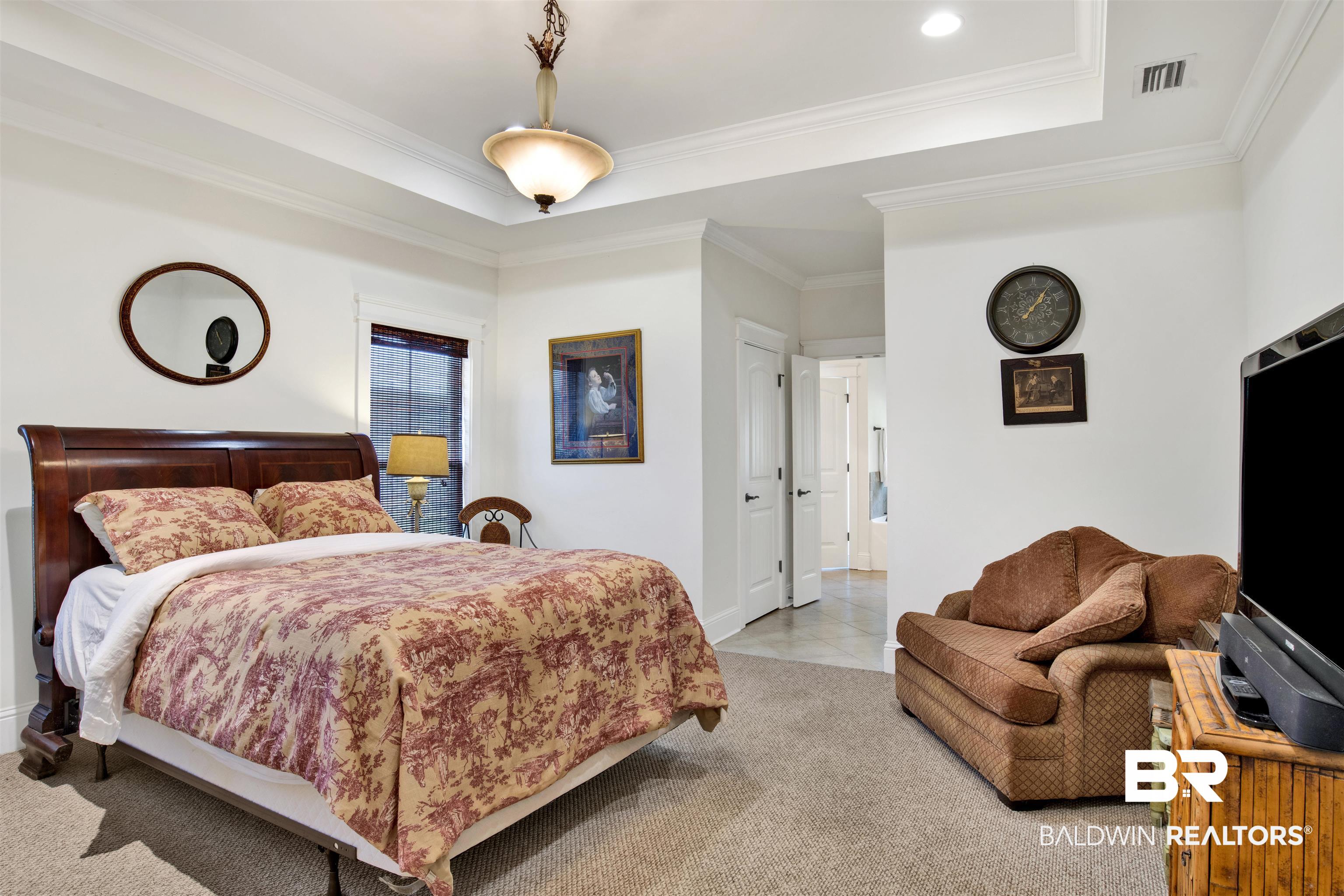 9240 Bay Point Drive Elberta, AL 36530 - Photo 21 of 22 Bedroom with carpet floors, a raised ceiling, and ornamental molding