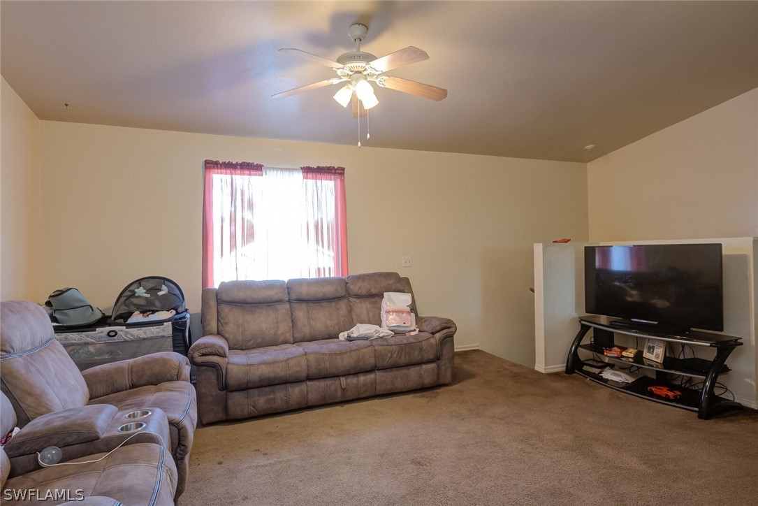 8314 Trillium Road Fort Myers, FL 33967 - Photo 5 of 23 a living room with furniture and a flat screen tv
