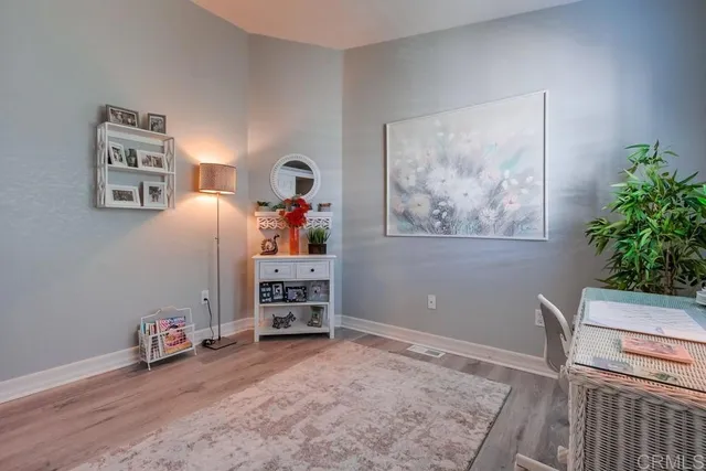 a bedroom with a bed and a table lamp