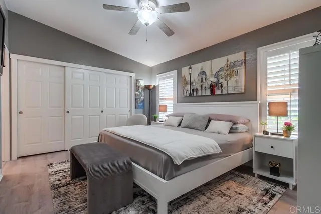 a spacious bedroom with a bed and glass windows