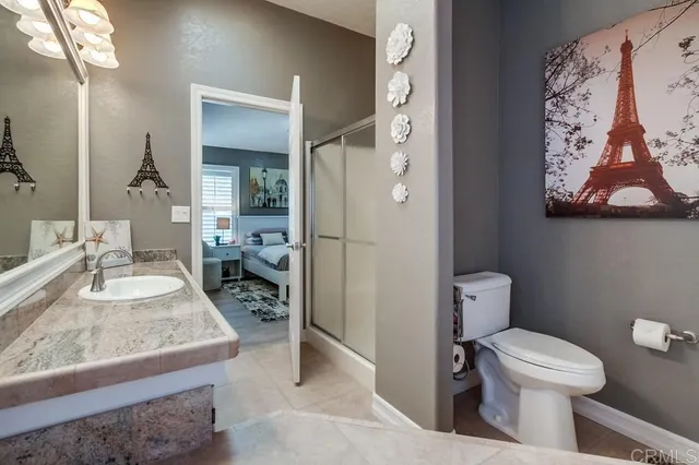 a bathroom with a granite countertop sink and a bathtub