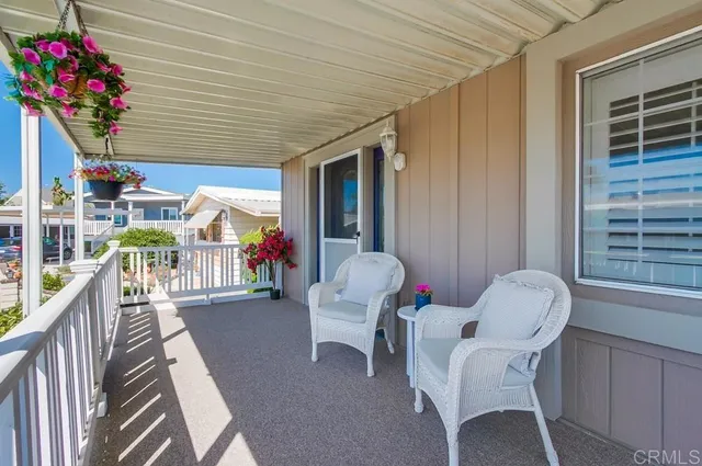 a view of a porch with furniture and a potted plant