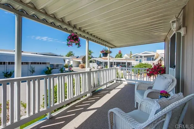 a view of a chairs and table in the balcony
