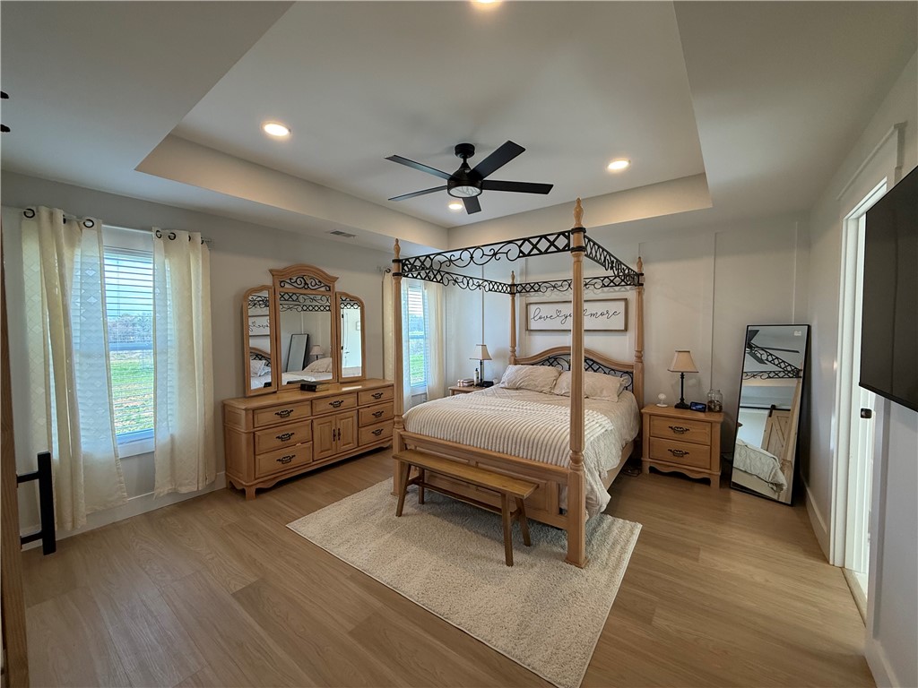 119 Dobbins Road Townville, SC 29689 - Photo 7 of 21 This spacious bedroom features ample natural light and a charming tray ceiling, creating an inviting atmosphere.