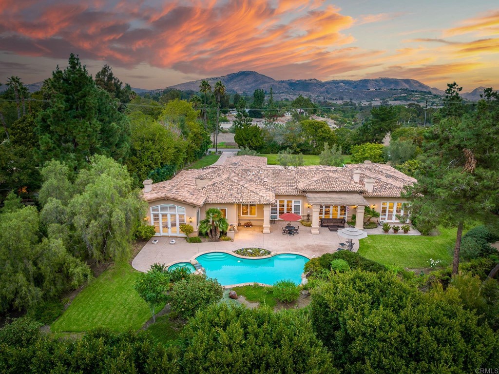 6723 El Montevideo Rancho Santa Fe, CA 92067 - Photo 1 of 1 an aerial view of a house with pool garden and mountain view in back