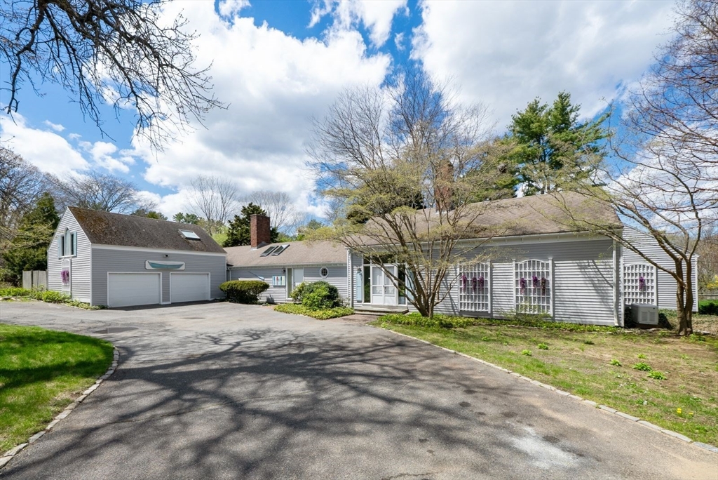 3 Proctor Street Manchester, MA 01944 - Photo 1 of 40 a front view of a house with a garden and trees