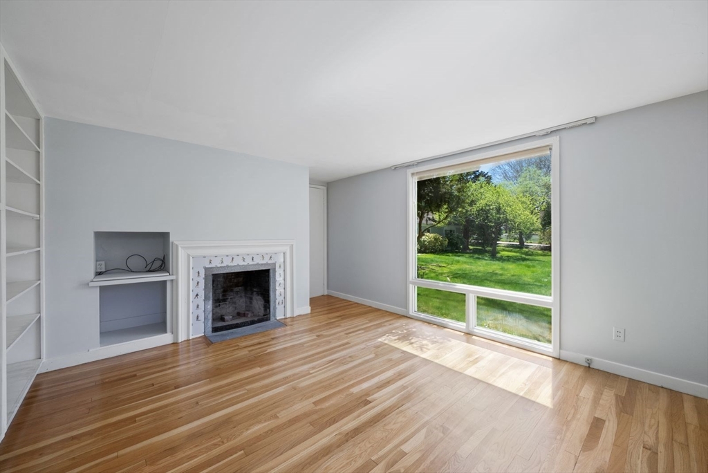 3 Proctor Street Manchester, MA 01944 - Photo 25 of 40 a view of empty room with wooden floor and fireplace