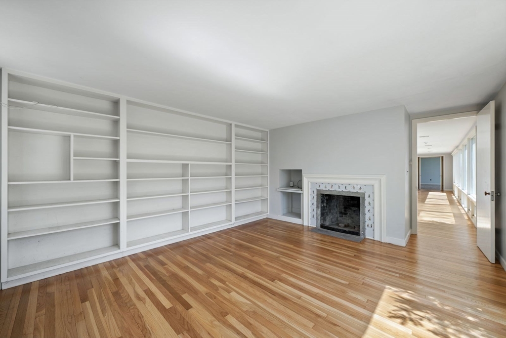 3 Proctor Street Manchester, MA 01944 - Photo 27 of 40 a view of an empty room with wooden floor fireplace and a window