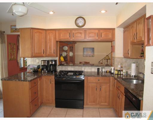 6 Sherwood Road Edison, NJ 08820 - Photo 2 of 10 a kitchen with kitchen island granite countertop a sink cabinets and stainless steel appliances
