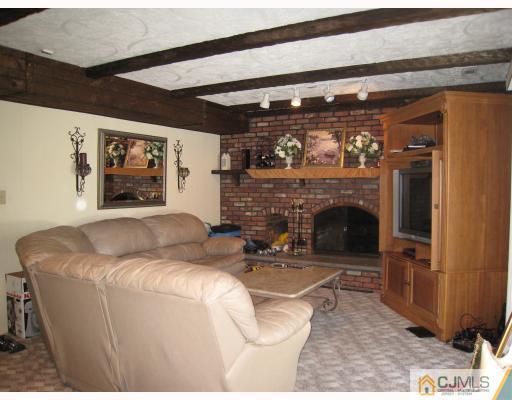 6 Sherwood Road Edison, NJ 08820 - Photo 6 of 10 a living room with furniture and a fireplace