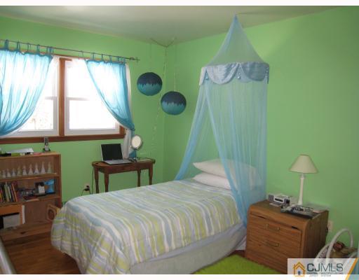 6 Sherwood Road Edison, NJ 08820 - Photo 8 of 10 a bedroom with a bed and a window