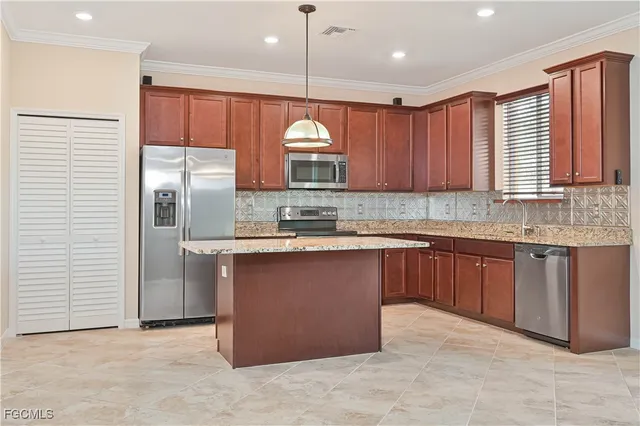 a kitchen with kitchen island granite countertop a sink window and refrigerator
