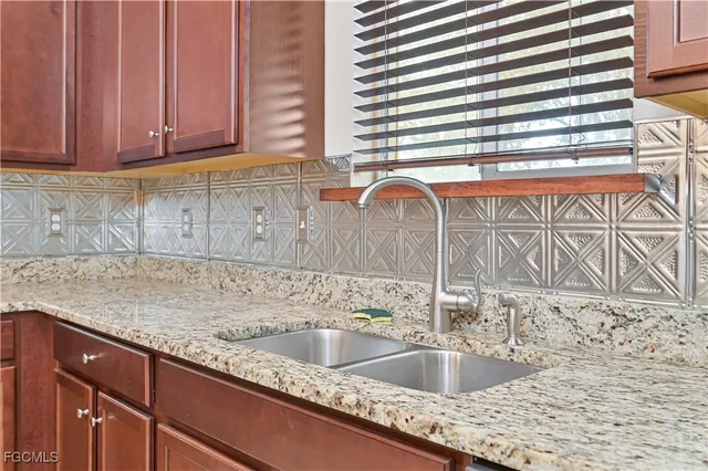 a kitchen with granite countertop a sink and a window