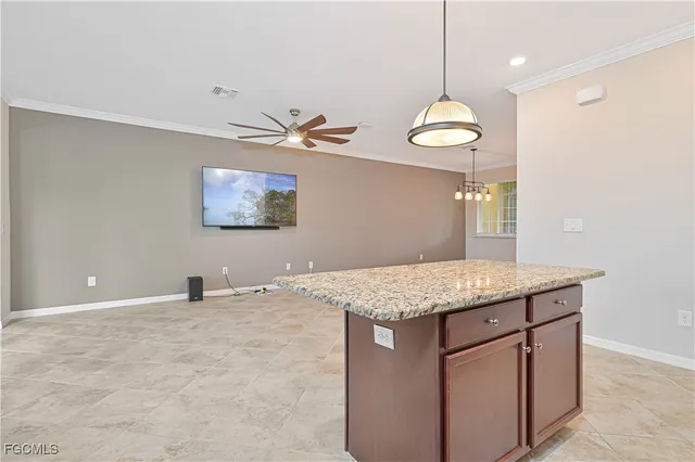 a view of a kitchen with a sink and chandelier