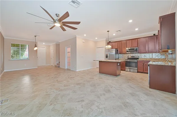 a large kitchen with cabinets and stainless steel appliances