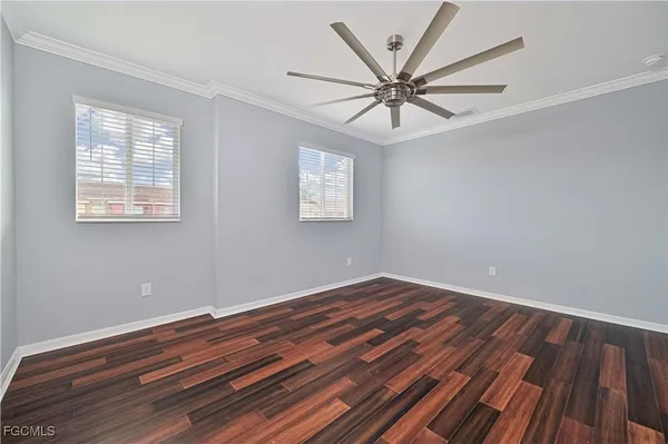 a view of room with window and wooden floor