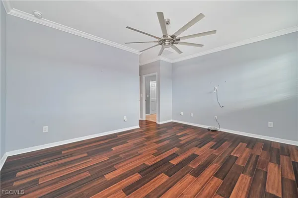 a view of a room with wooden floor and closet area