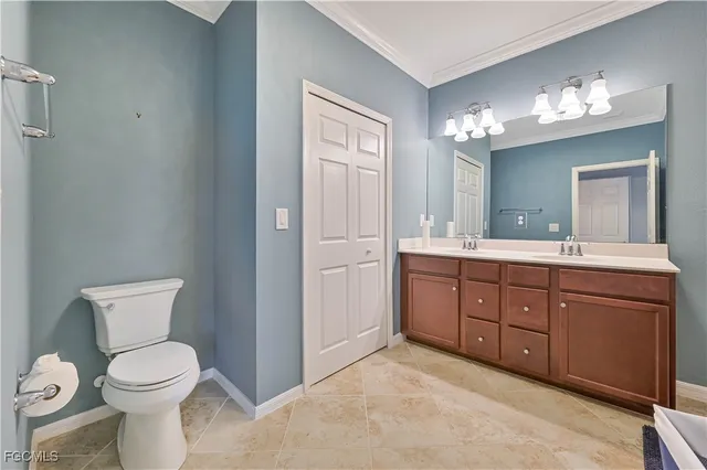 a spacious bathroom with a toilet sink and mirror