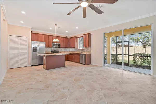 a large kitchen with stainless steel appliances granite countertop a refrigerator a oven a sink with island and windows