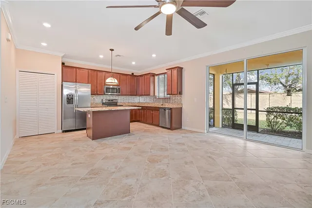 a large kitchen with stainless steel appliances granite countertop a refrigerator a oven a sink with island and windows