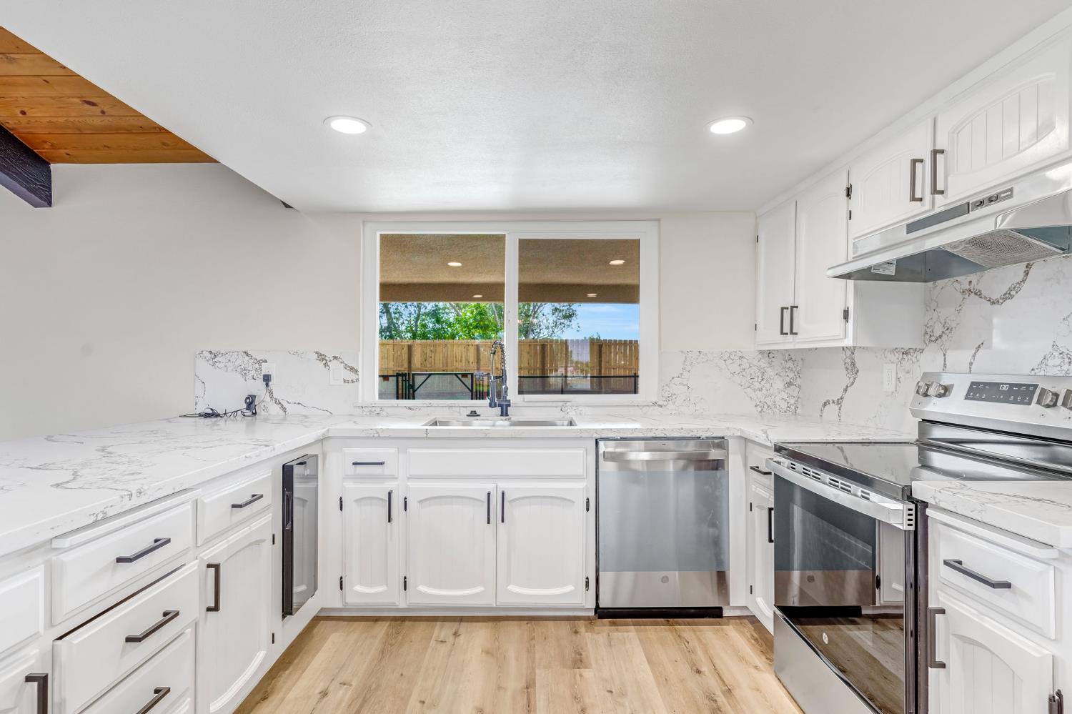 16860 Mark Road Madera, CA 93636 - Photo 11 of 44 a kitchen with a sink stove and cabinets