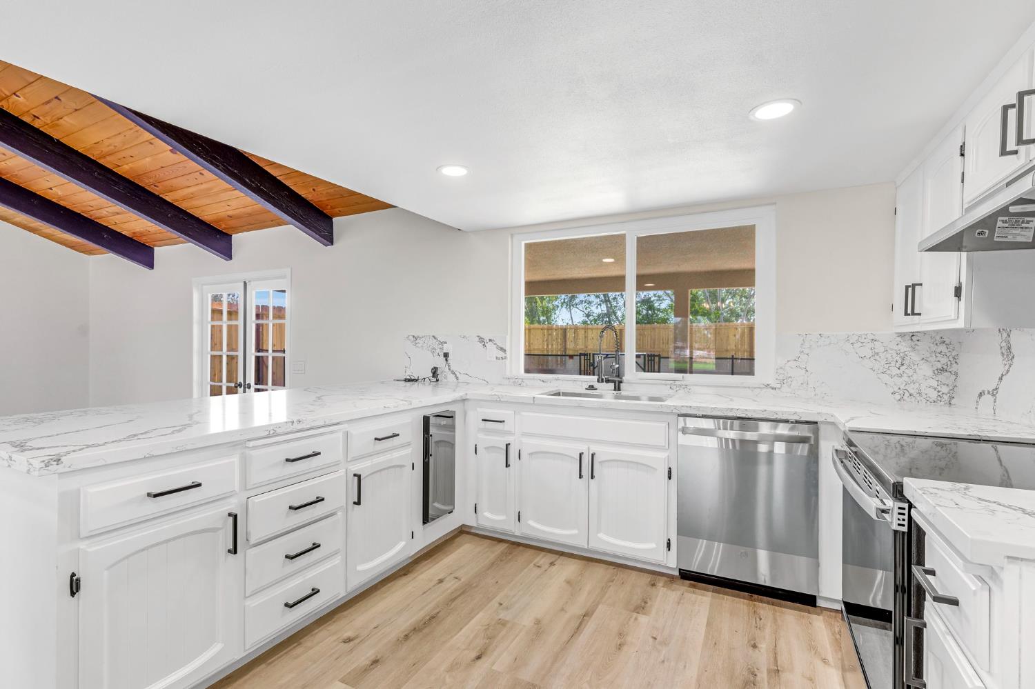 16860 Mark Road Madera, CA 93636 - Photo 13 of 44 a kitchen with granite countertop white cabinets and white appliances