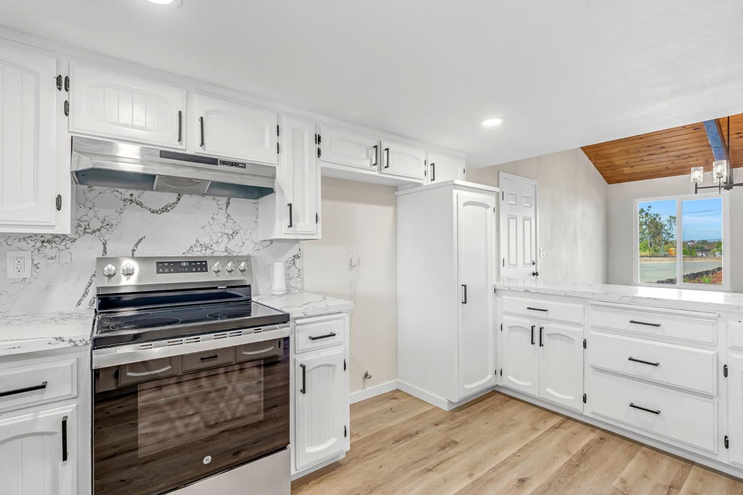 16860 Mark Road Madera, CA 93636 - Photo 15 of 44 a kitchen with cabinets appliances and wooden floor