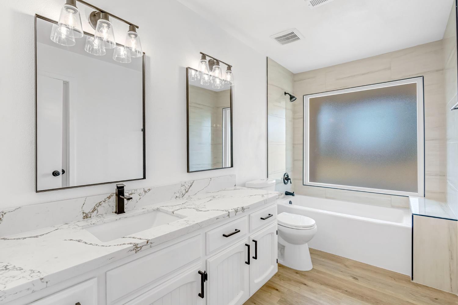 16860 Mark Road Madera, CA 93636 - Photo 20 of 44 a bathroom with a double vanity sink mirror double and a bathtub