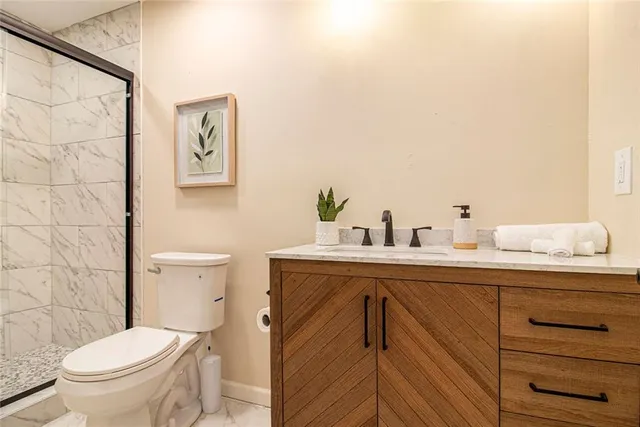 a bathroom with a sink mirror vanity and toilet